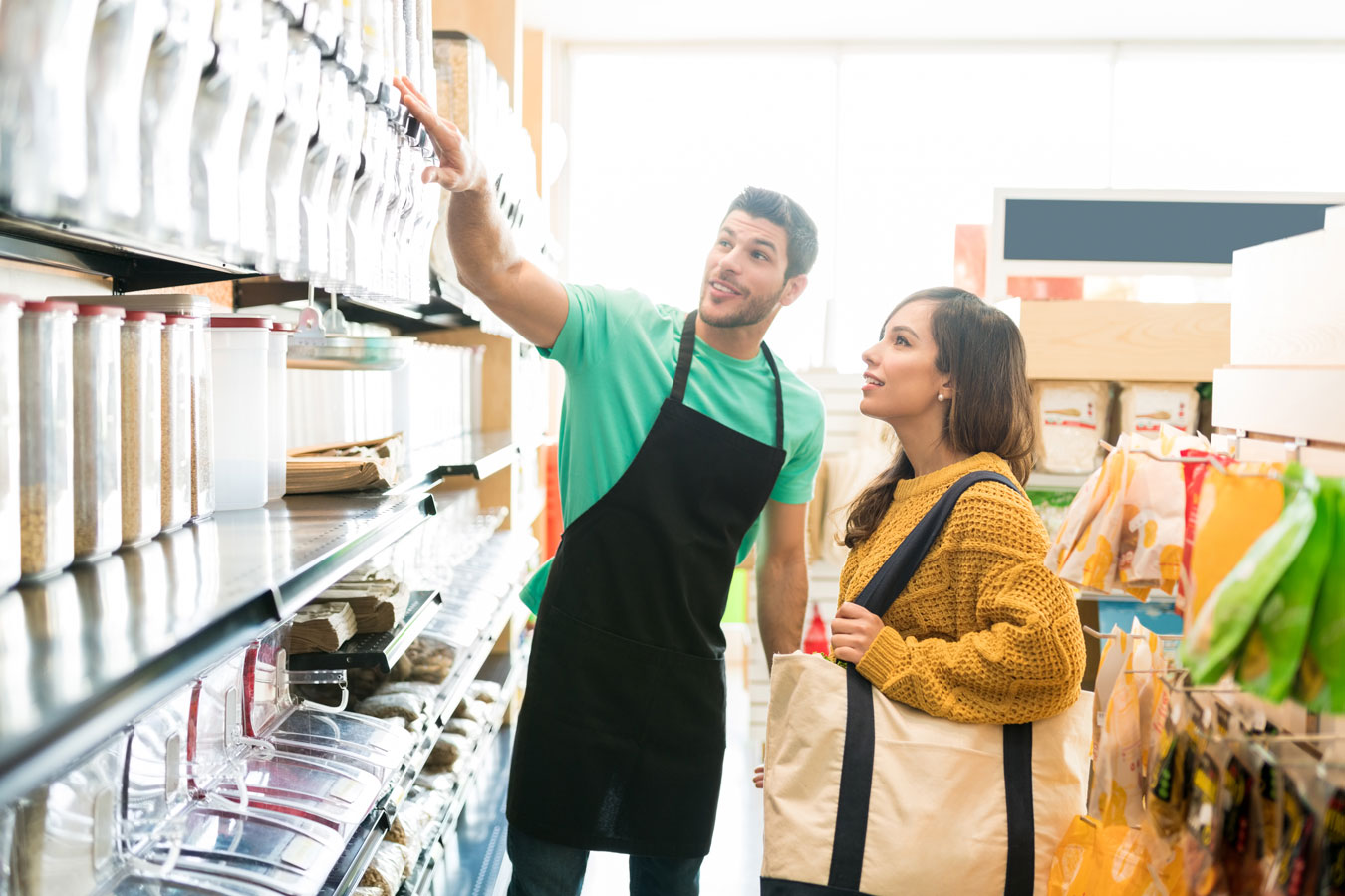 Employee showing customer items on a shelf