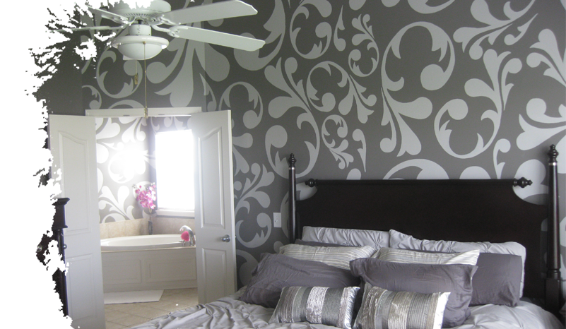 Light gray on gray floral mural on wall behind bed