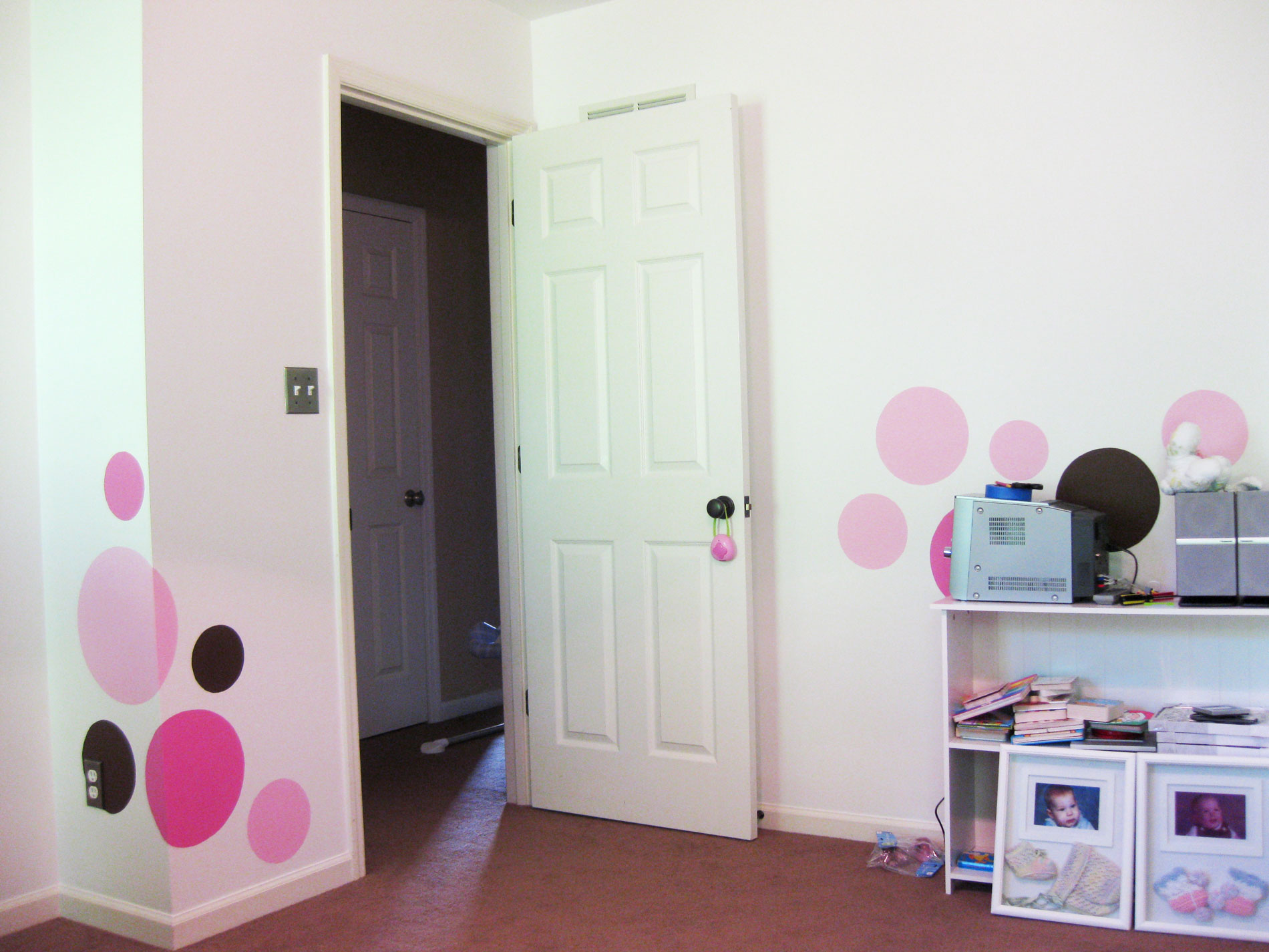Brown and pink spots painted on the walls of a baby's room